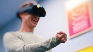 Mark Zuckerberg wearing the Meta Quest Pro, which is blurred, and playing a game with hand tracking.