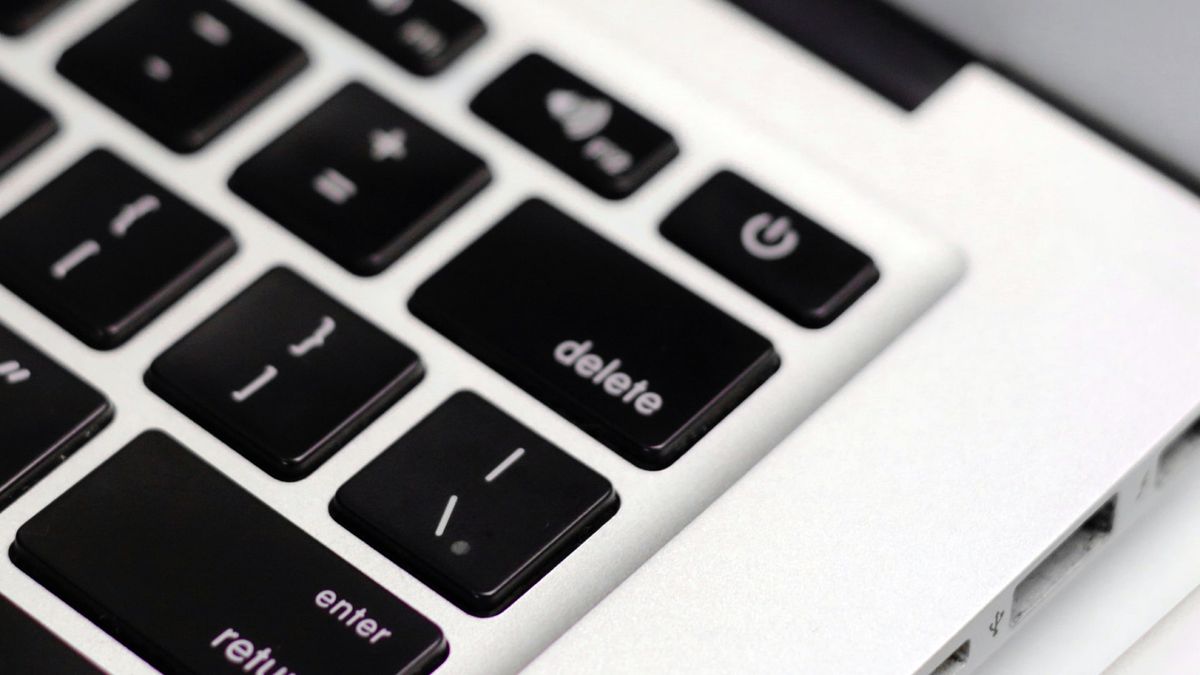 A close-up of a Mac&#039;s keyboard, showing the Delete key.