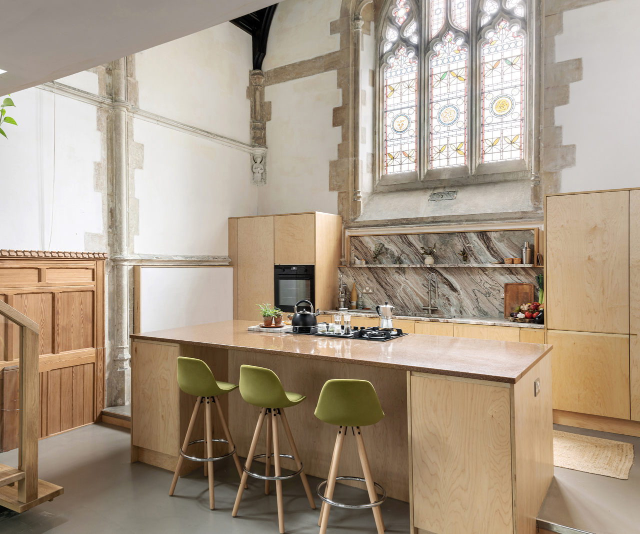 Kitchen with island and stain glass window behind the counter