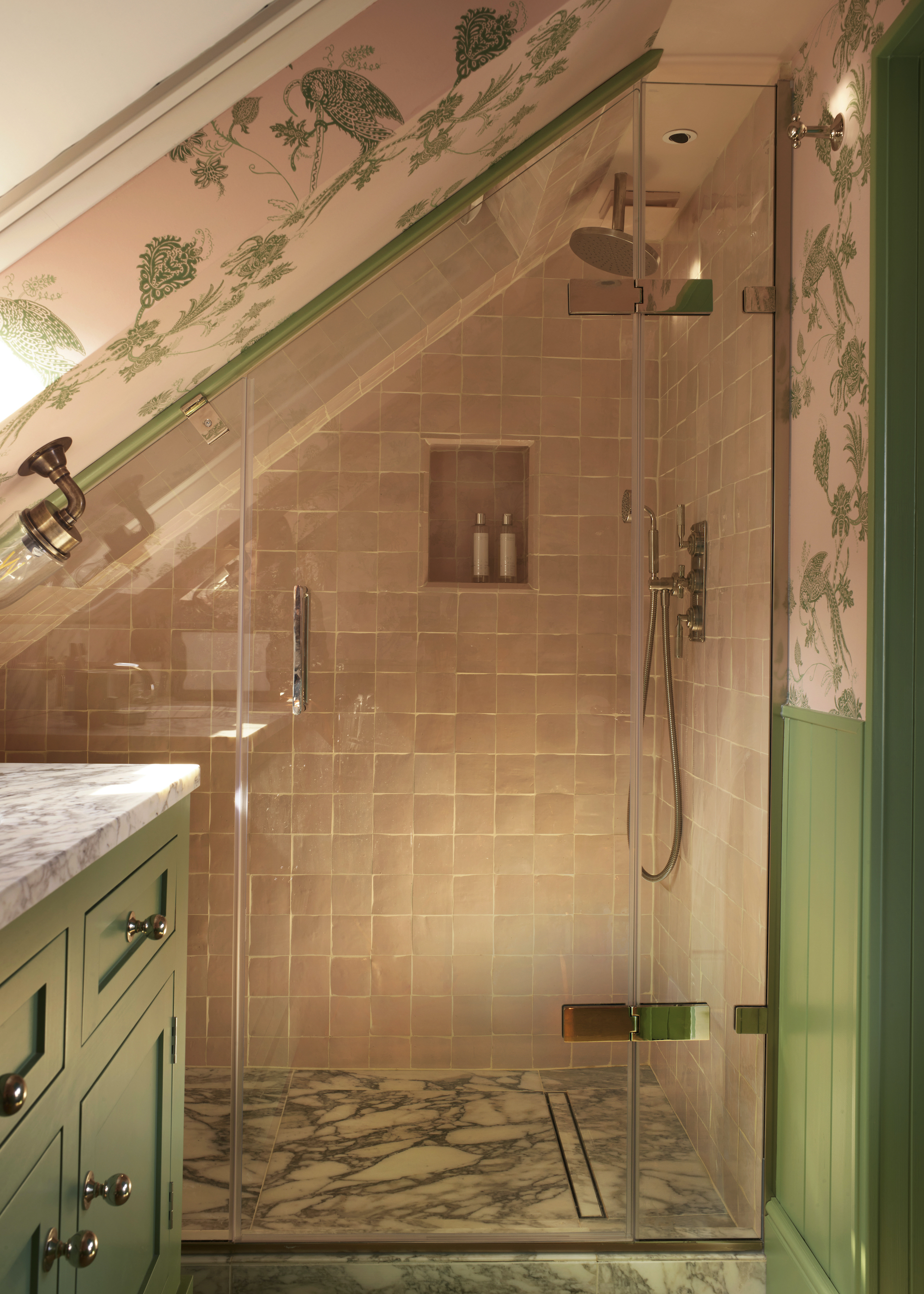 loft bathroom with pink tiles, wallpaper and green woodwork