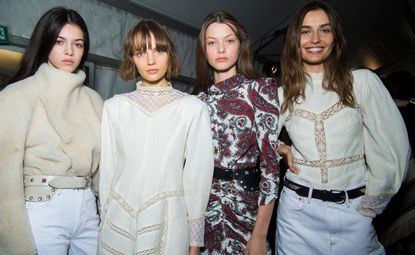 Isabel Marant's A/W 2018 show with models wearing cream shearling jumpers, white lace dresses and a paisley jumpsuit