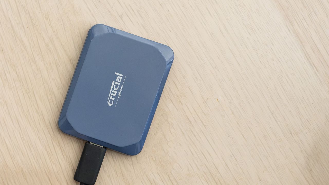 A Crucial X10 external SSD in blue with USB Type-C connector cable.