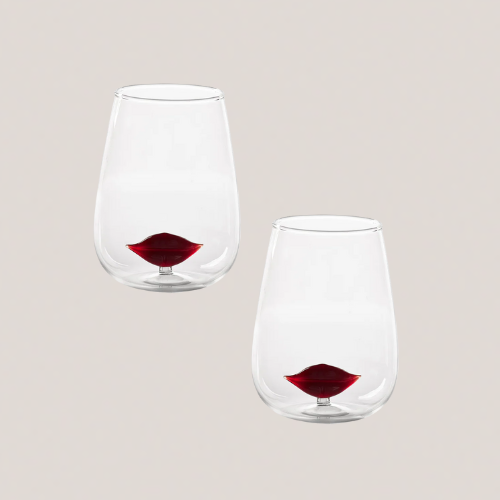 Two glass tumblers with glass lip shapes inside
