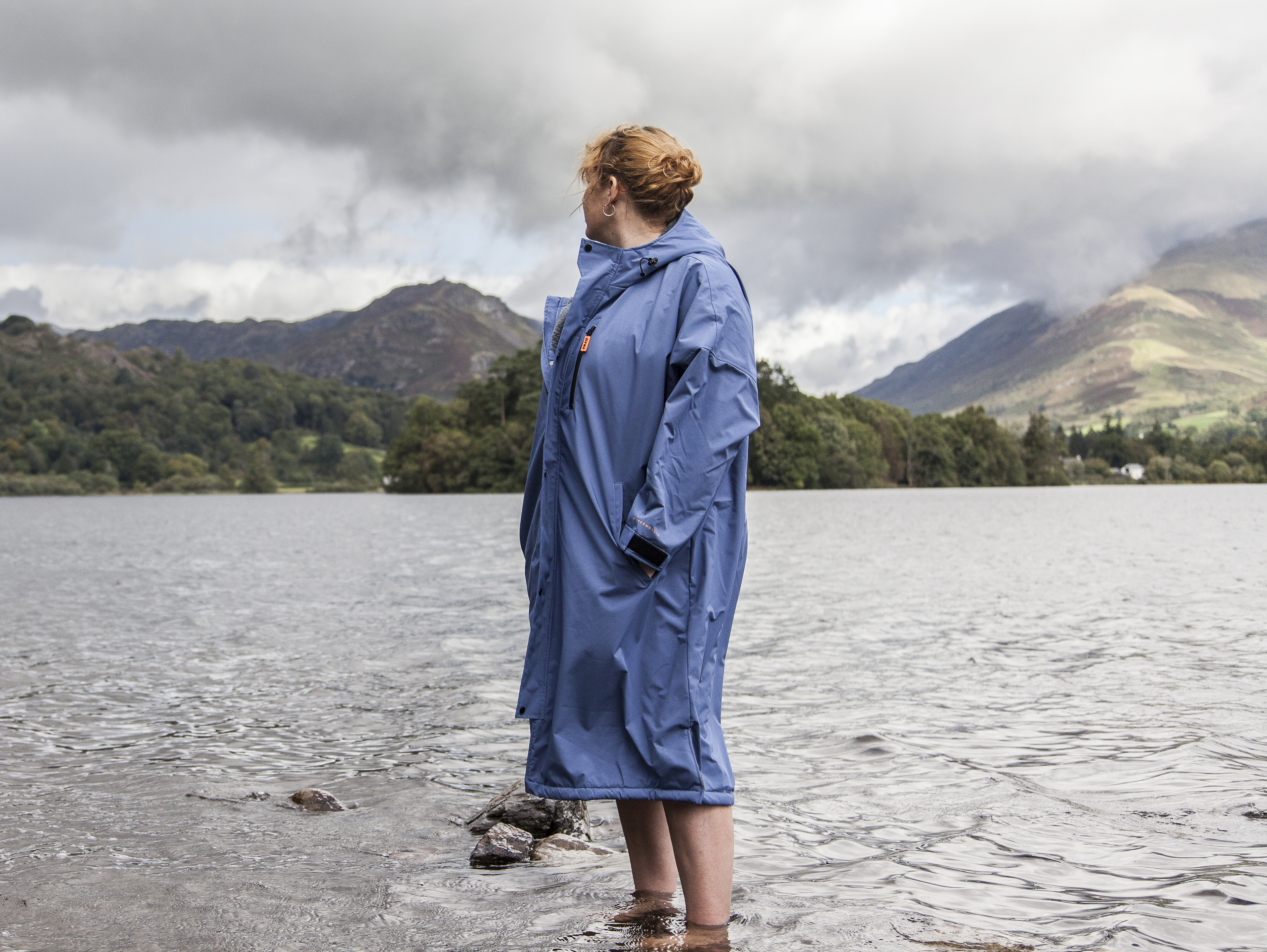 Woman standing in Grasmere lake wearing Zone3 thermotech changing robe