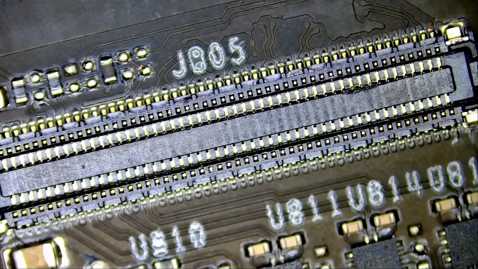 A screenshot from a NorthridgeFix YouTube video, showing a close-up image of the internal PCB-to-PCB fixed connector.