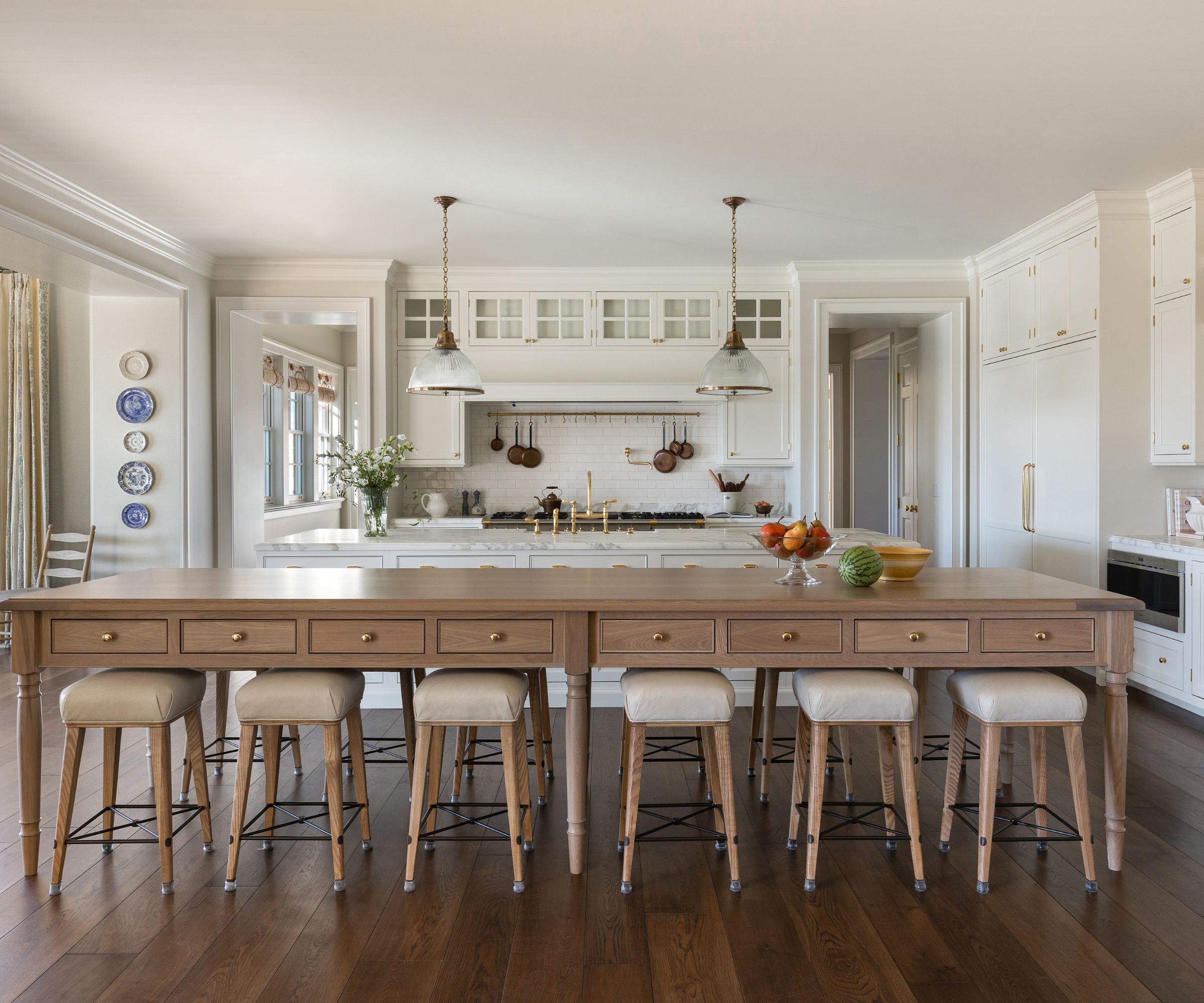 kitchen island table with stools and white cabinetry