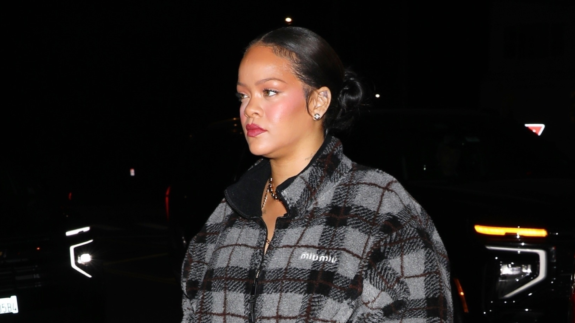 Rihanna embraces the plaid trend in a Miu Miu checked-pattern teddy fleece jacket and snakeskin boots for dinner at Italian restaurant Giorgio Baldi