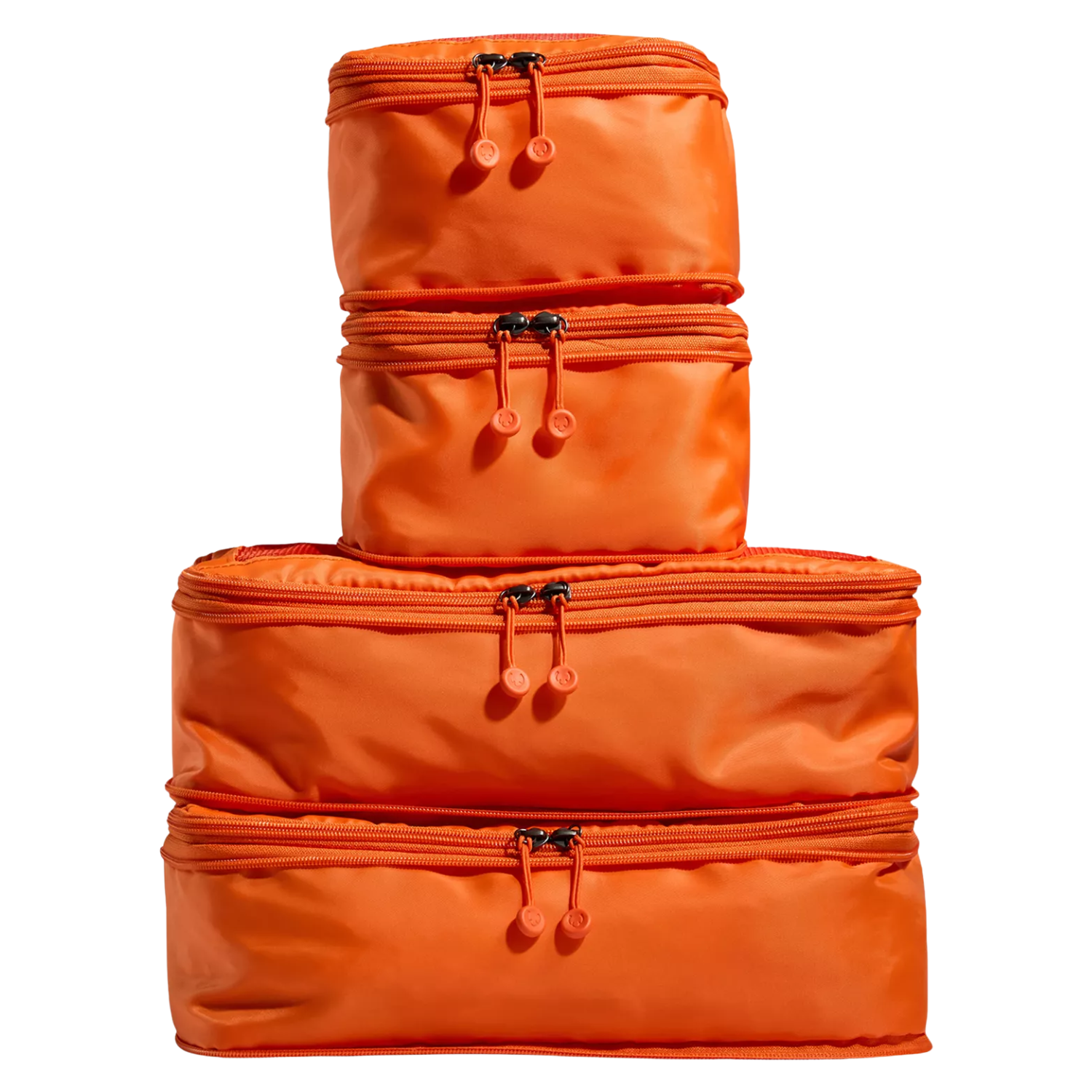A stack of four coral colored packing cubes