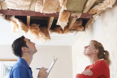 Home insurance costs are rising as a builder And client Inspect roof damage.