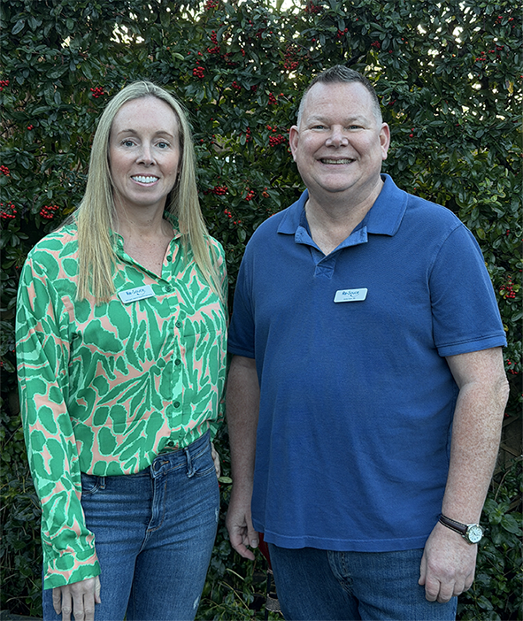 Beky Cann and Gordon Dutch posing in front of a bush.