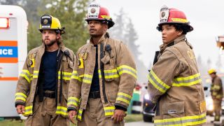 Pictured (L-R): Max Thieriot as Bode Leone, Jordan Calloway as Jake Crawford, and Jules Latimer as Eve Edwards. They're all standing in fire gear. 