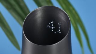 a black plastic coffee doser with an aesthetically pleasing design and a curved built-in LED screen