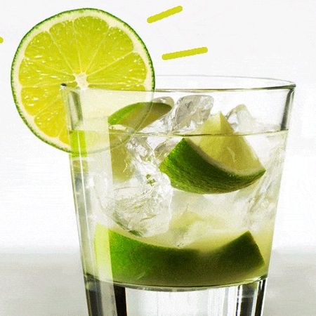 Caipirinha with a lemon slice on the glass rim.