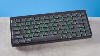 The NuPhy Node75 on a stone surface with a blue background