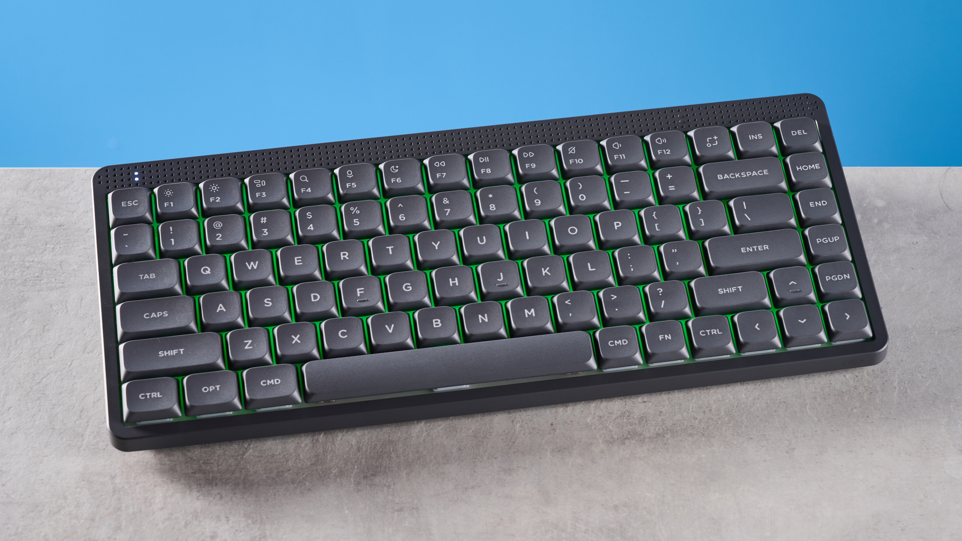 The NuPhy Node75 on a stone surface with a blue background