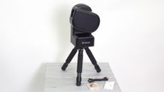 ZWO Seestar S50 on a table against a white wall
