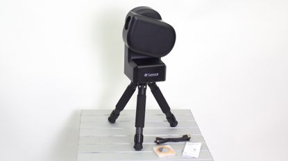 ZWO Seestar S50 on a table against a white wall
