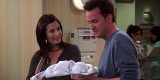 Monica and Chandler hold one of their new children in the series finale of Friends.
