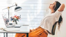 Woman leans back in the chair in her home office