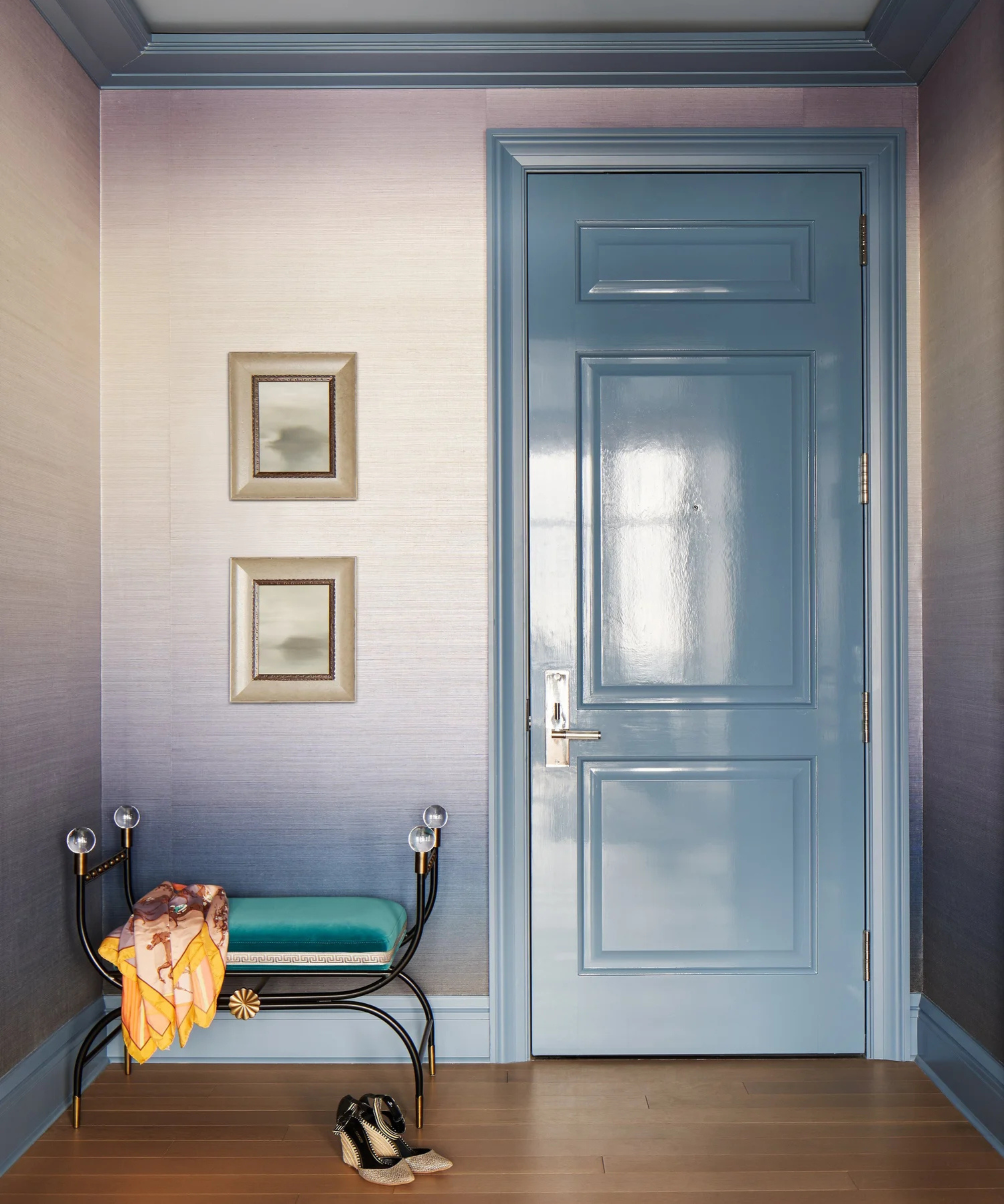 a doorway with a door painted in high gloss blue paint, and a wall with ombre purple wallpaper