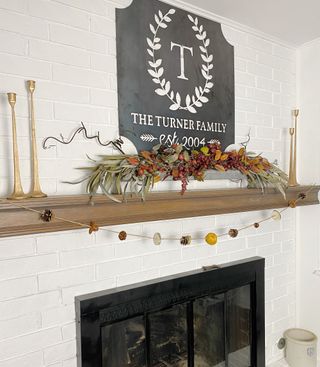 Fall garland on wooden fireplace mantelpiece