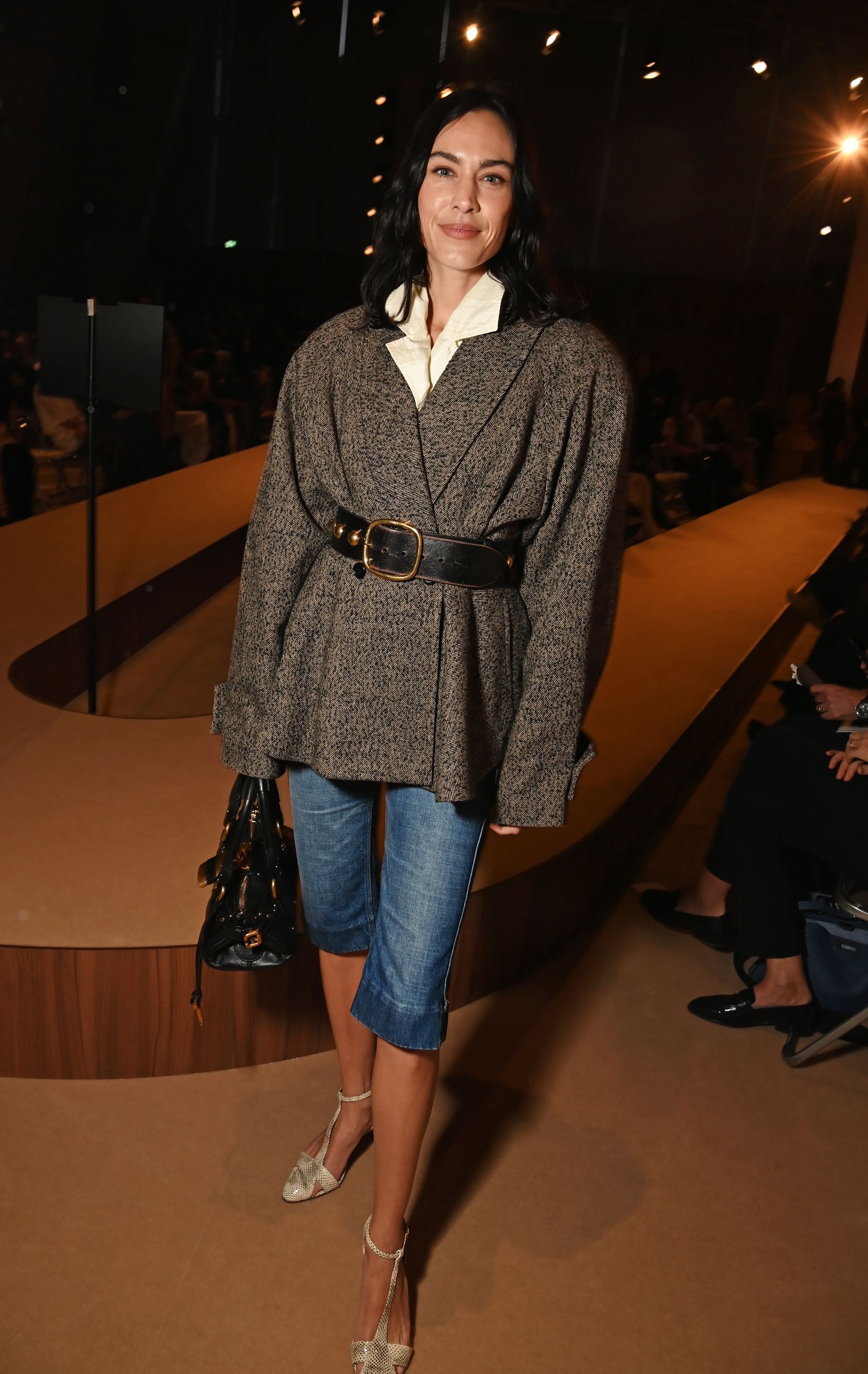 Alexa Chung wears denim capri pants while out in Paris attending Chloé's spring/summer 2026 show.