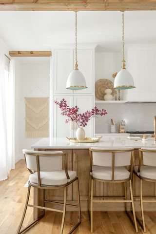 modern farmhouse kitchen with island and white chairs with white pendant lights