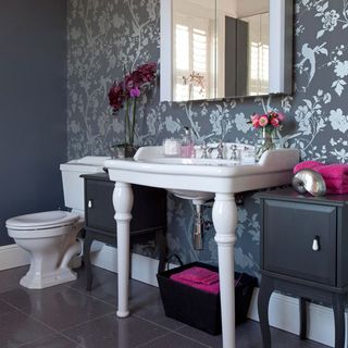 bathroom area with wash basin mirror wallpaper and grey backdrop