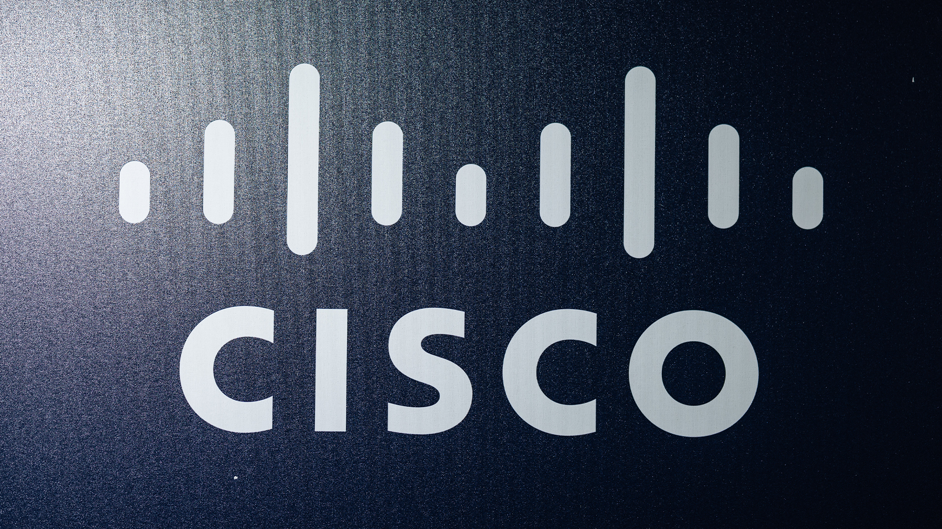 Cisco logo and branding in white lettering pictured against a grey-blue background at the InCyber Forum in Lille, France.
