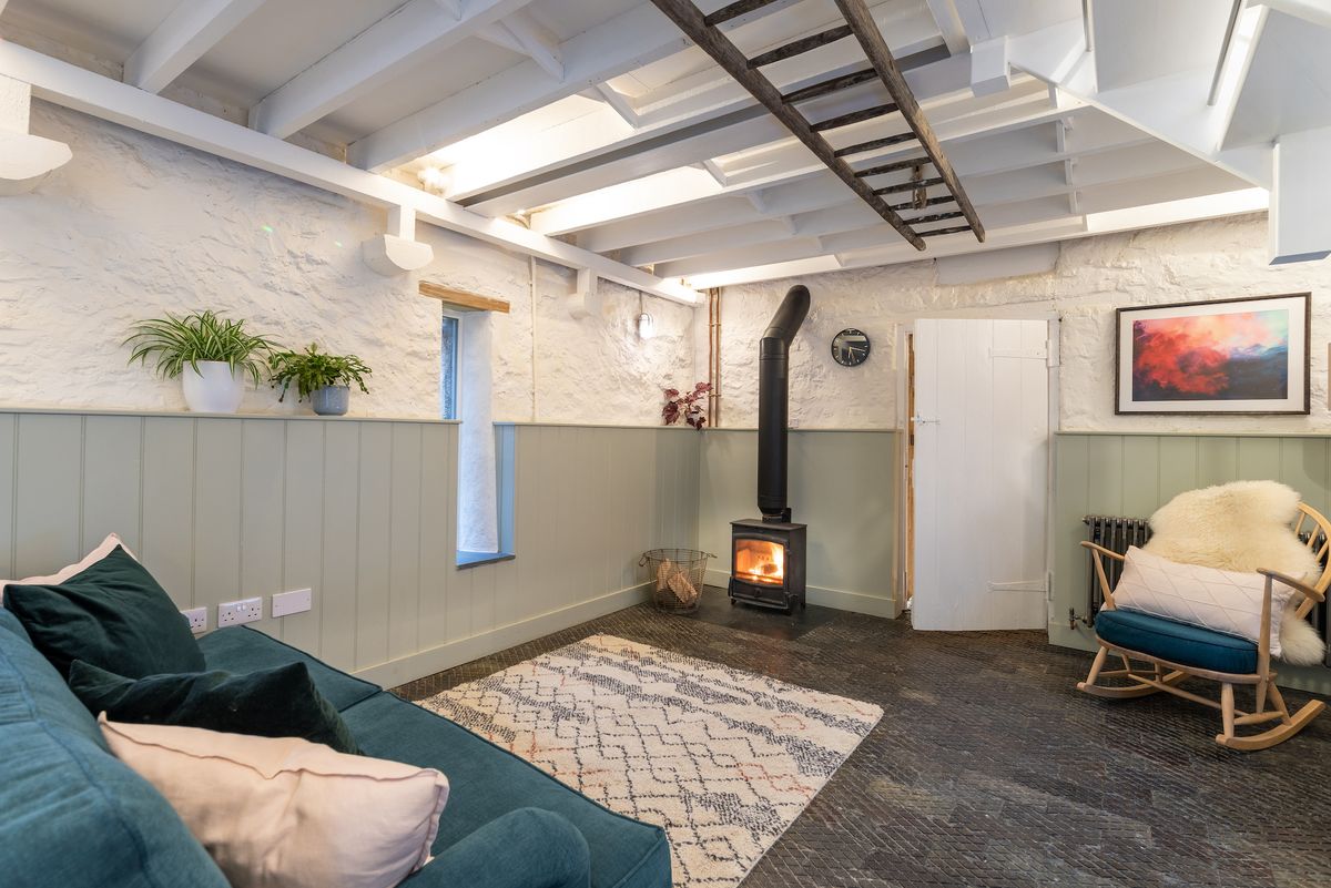 cosy living rom with wood panelling and stove