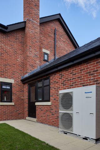 An air source heat pump installed outside of a home
