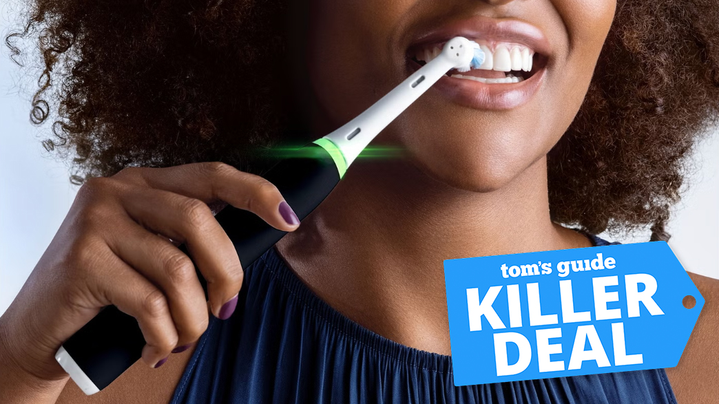 A woman brushing her teeth with the Oral-B IO3 toothbrush