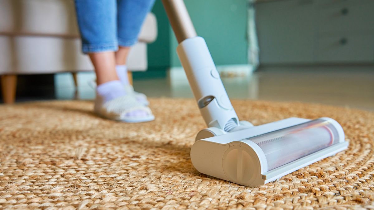 White vacuum cleaner on a jute rug