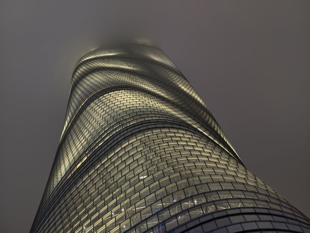 Tall building disappearing into clouds lit up at night taken on the vivo X300 pro