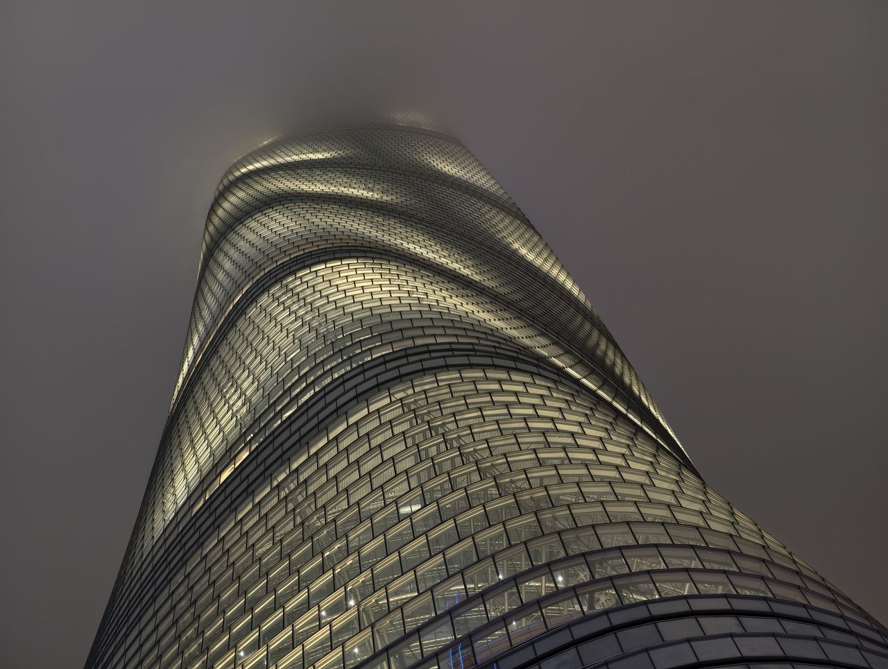 Tall building disappearing into clouds lit up at night taken on the vivo X300 pro