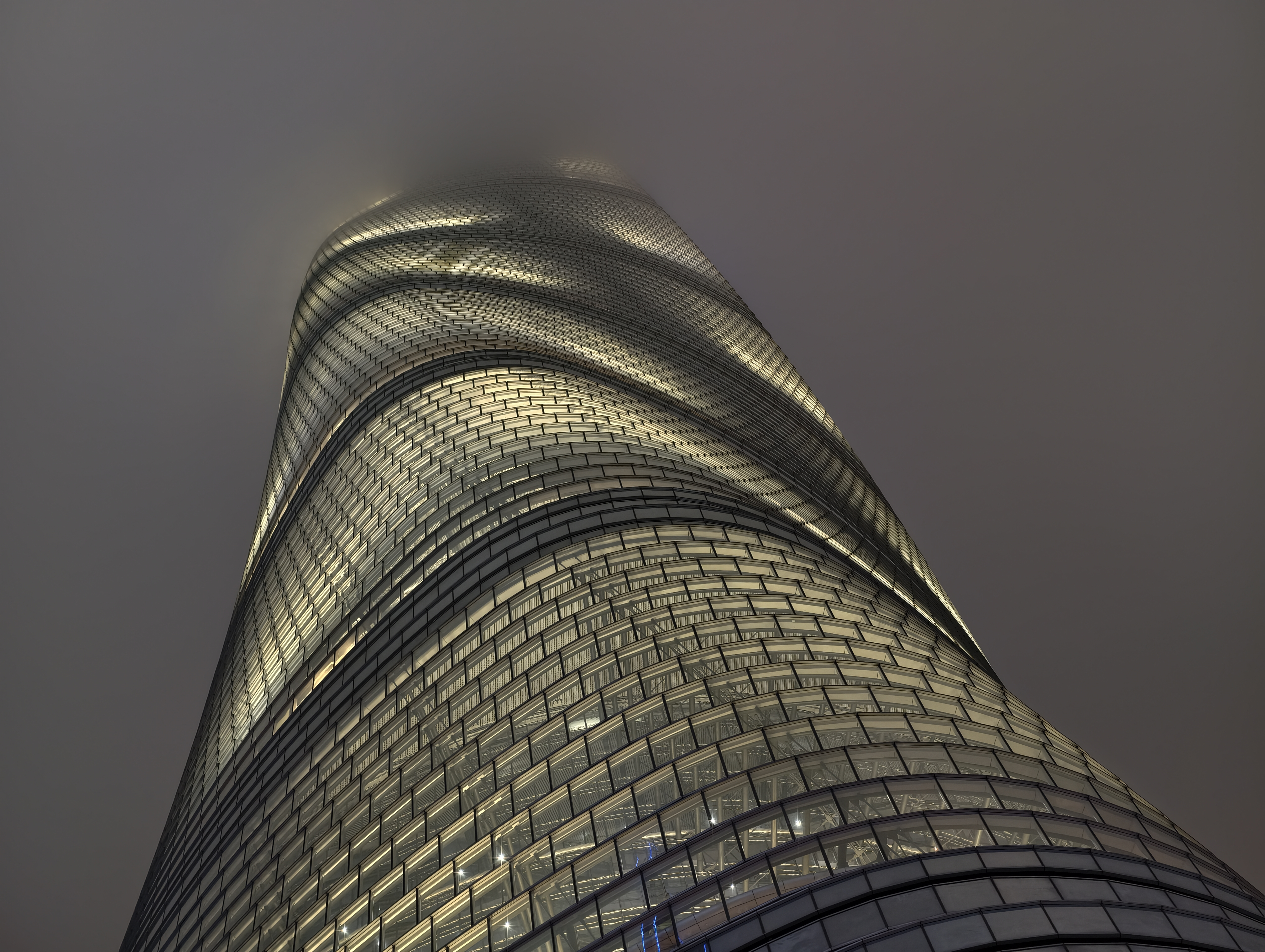 Tall building disappearing into clouds lit up at night taken on the vivo X300 pro
