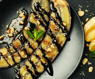 Air Fried Banana dessert with a chocolate drizzle and chopped hazelnuts