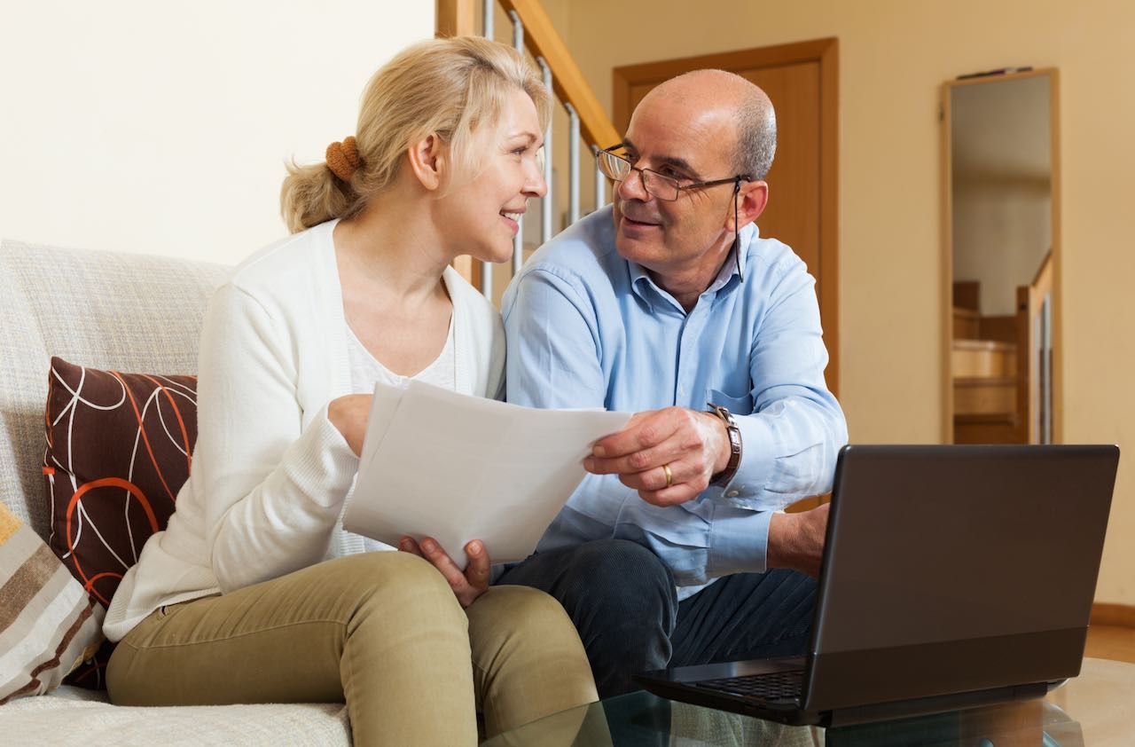 Mature couple with documents and notebook