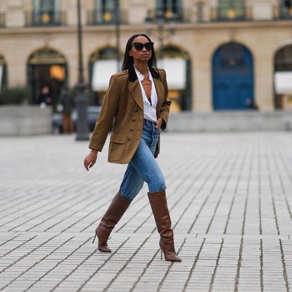 woman wearing a blazer and stiletto boots