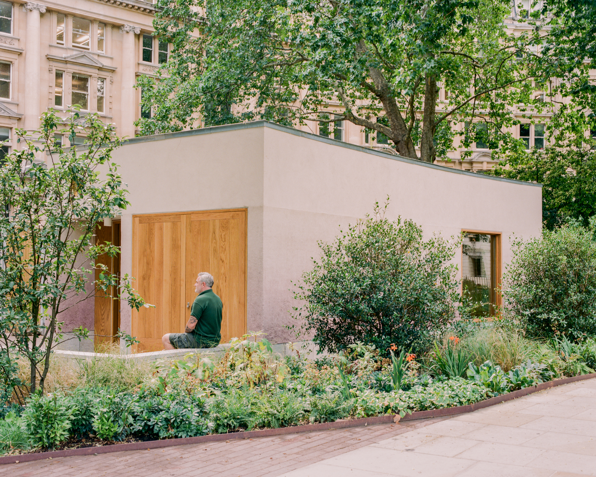 view of Finsbury Circus Parks Office, a minimalist, earthy building set among leafy garden