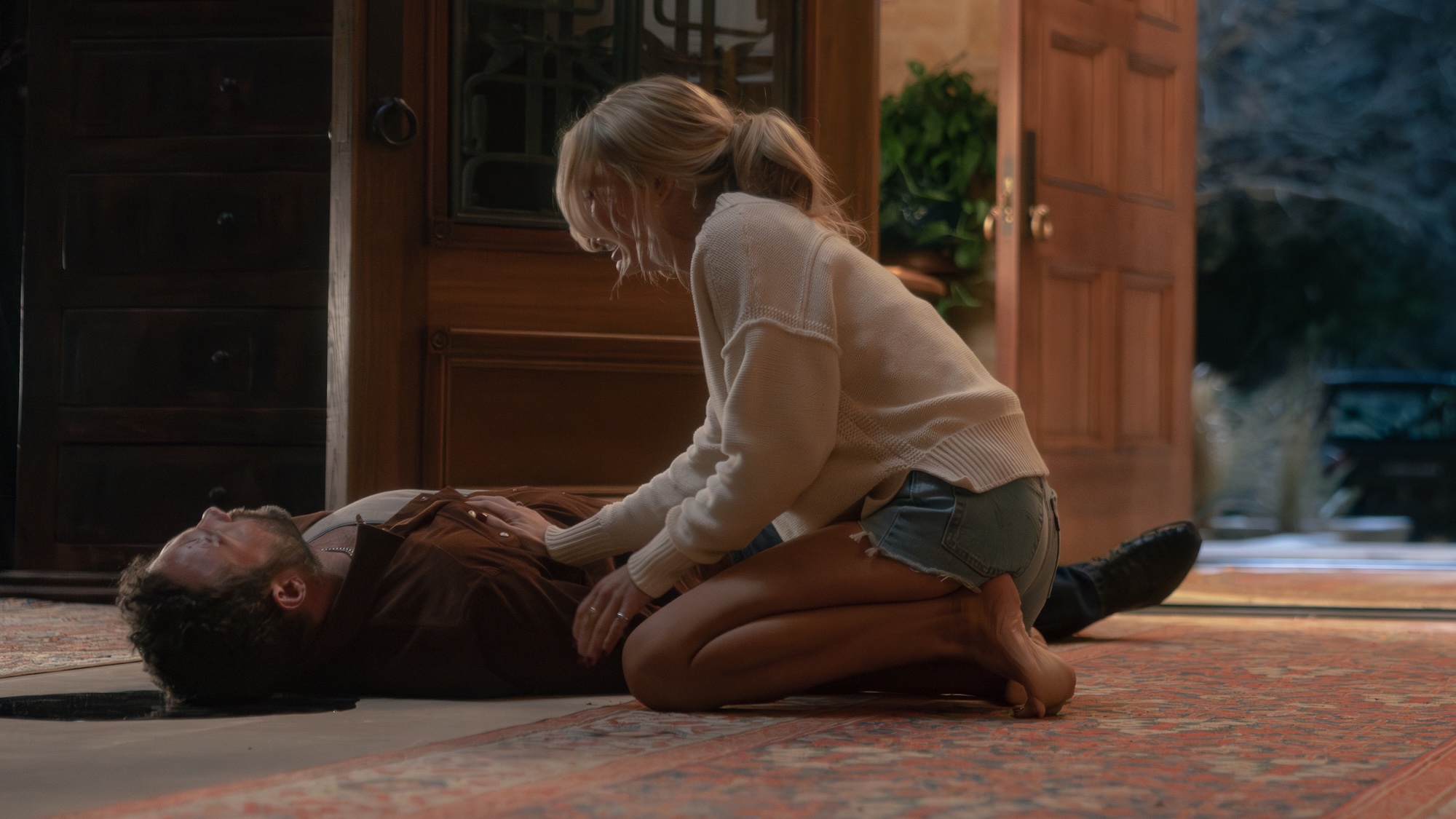 Oreana sobbing while kneeling near the corpse of her father Rob-Will in Dutton Ranch Season 1 finale