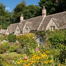 Pretty country cottages and gardens in the picturesque Cotswolds village of Bibury
