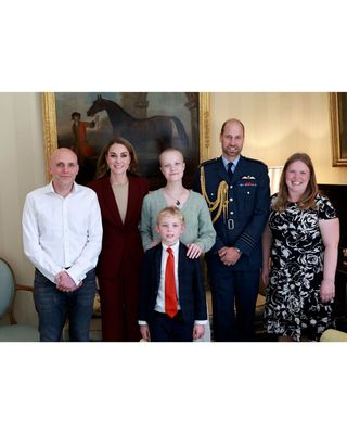 Kate Middleton, Prince William, teenage photographer Liz Hatton, her parents and brother posing in front of a painting of a horse