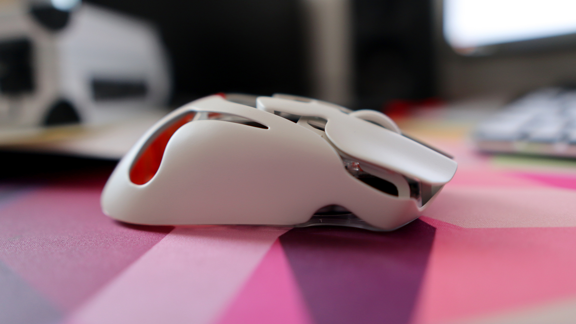 AngryMiao AM Infinity.97 gaming mouse on a colorful desk
