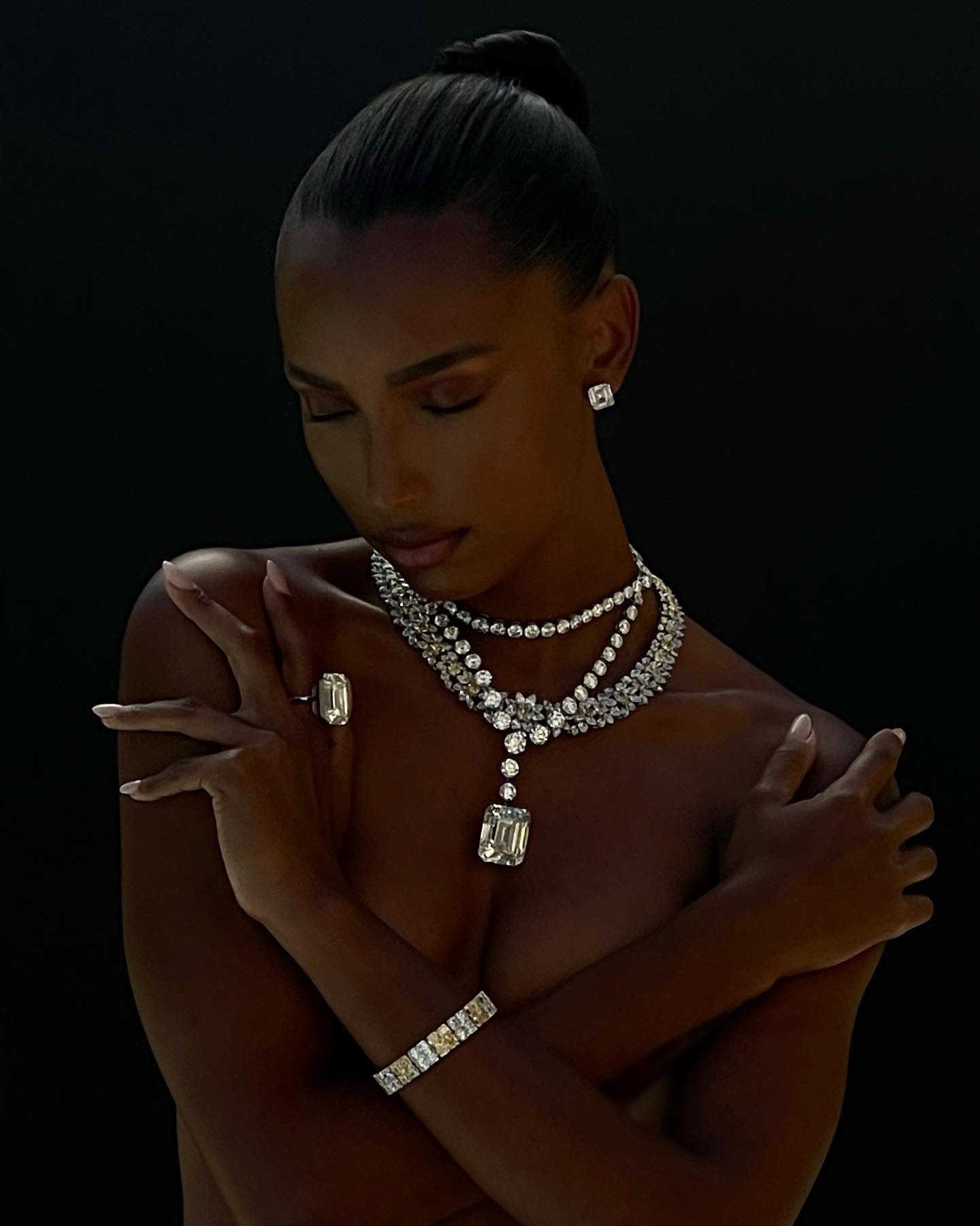 Woman wearing diamond stud earrings.