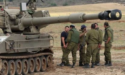 Israeli soldiers prepare an artillery emplacement overlooking Gaza on Nov. 19.