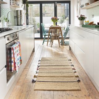 White modern kitchen with jute runner rug.