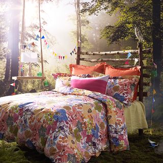 woodland photo wallpaper floral bed linen wooden headboard and bunting