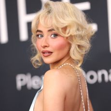 Sabrina Carpenter looks over her shoulder