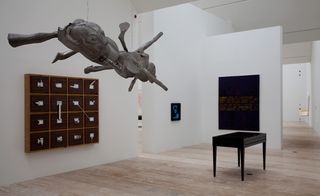 Multiple art sculptures in white room